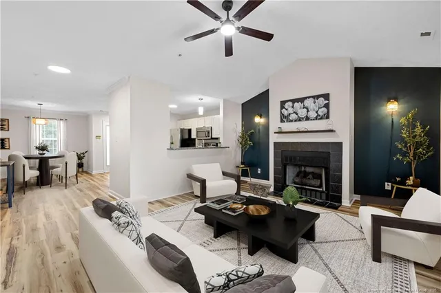 a living room with furniture and a fireplace