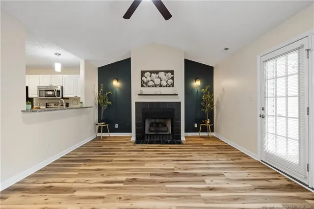 a view of kitchen and hall with wooden floor