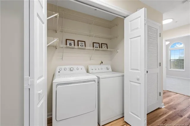 a view of washer and dryer with kitchen in the background