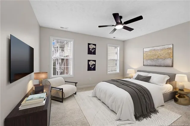 a bedroom with a bed and a flat screen tv