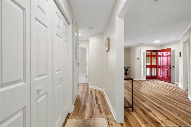 a view of a bedroom with wooden floor and windows