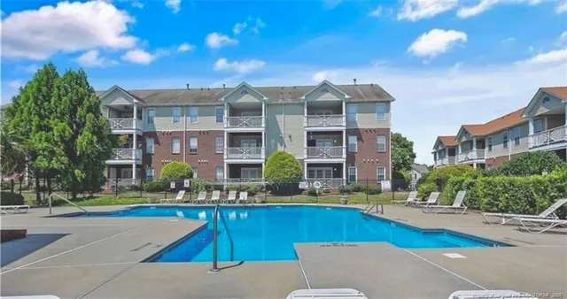 a front view of building with yard and outdoor seating