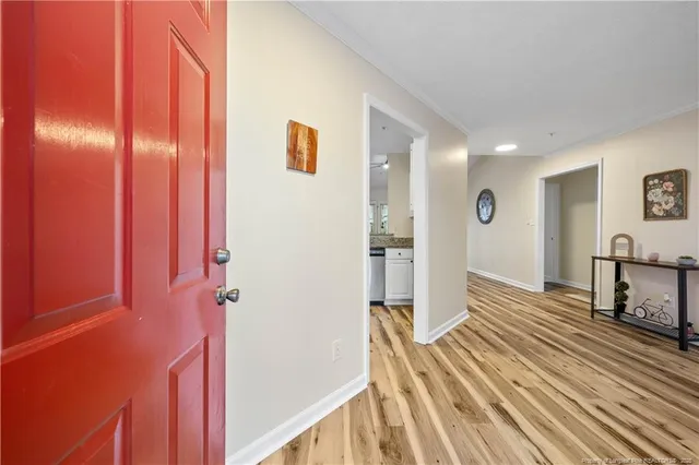 a view of a bedroom with wooden floor and stairs