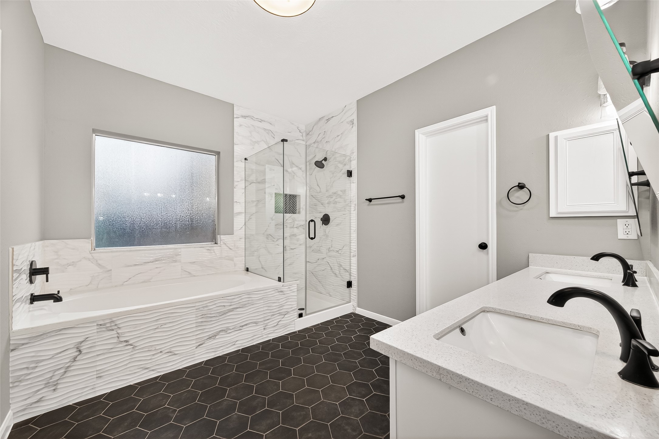 23810 Spring Way Drive Spring, TX 77373 - Photo 17 of 35 a bathroom with a tub sink and mirror