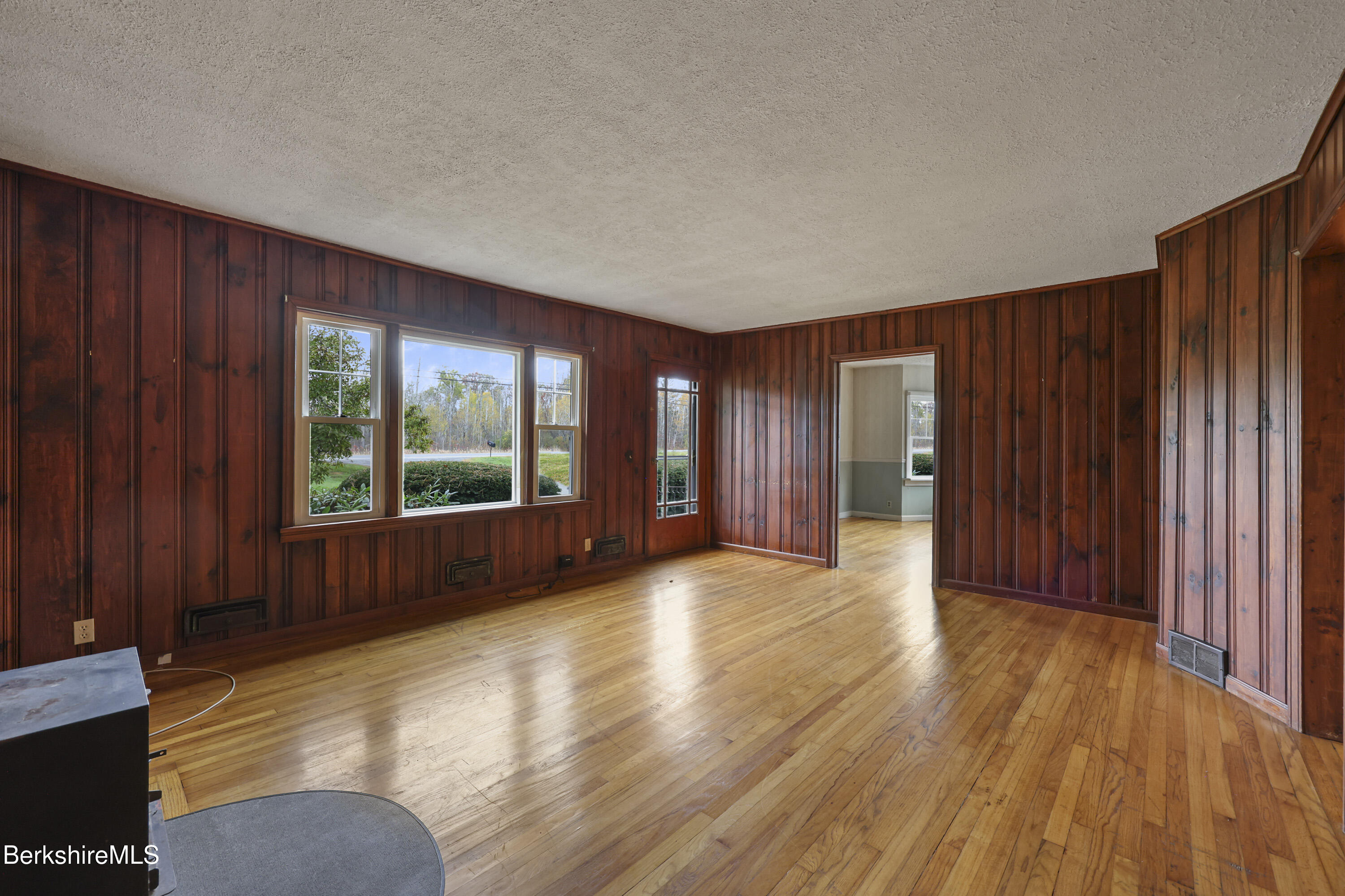 399 State Road Richmond, MA 01201 - Photo 12 of 43 a view of an empty room with wooden floor and a window