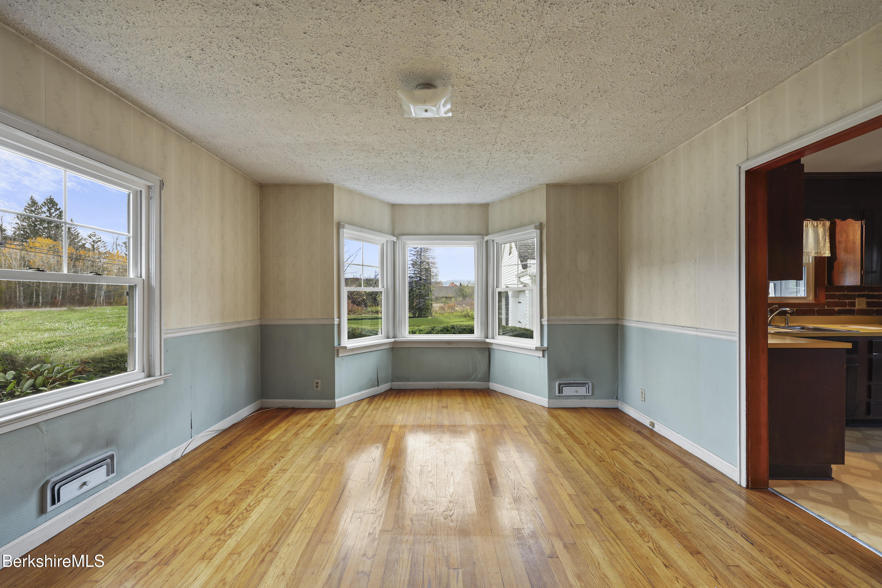 399 State Road Richmond, MA 01201 - Photo 14 of 43 a view of empty room with wooden floor and fan