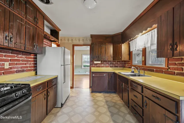 a kitchen with granite countertop a stove and a refrigerator