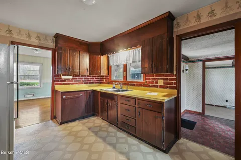 a kitchen with a stove a sink and a refrigerator
