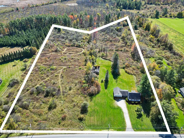 an aerial view of a houses with a yard
