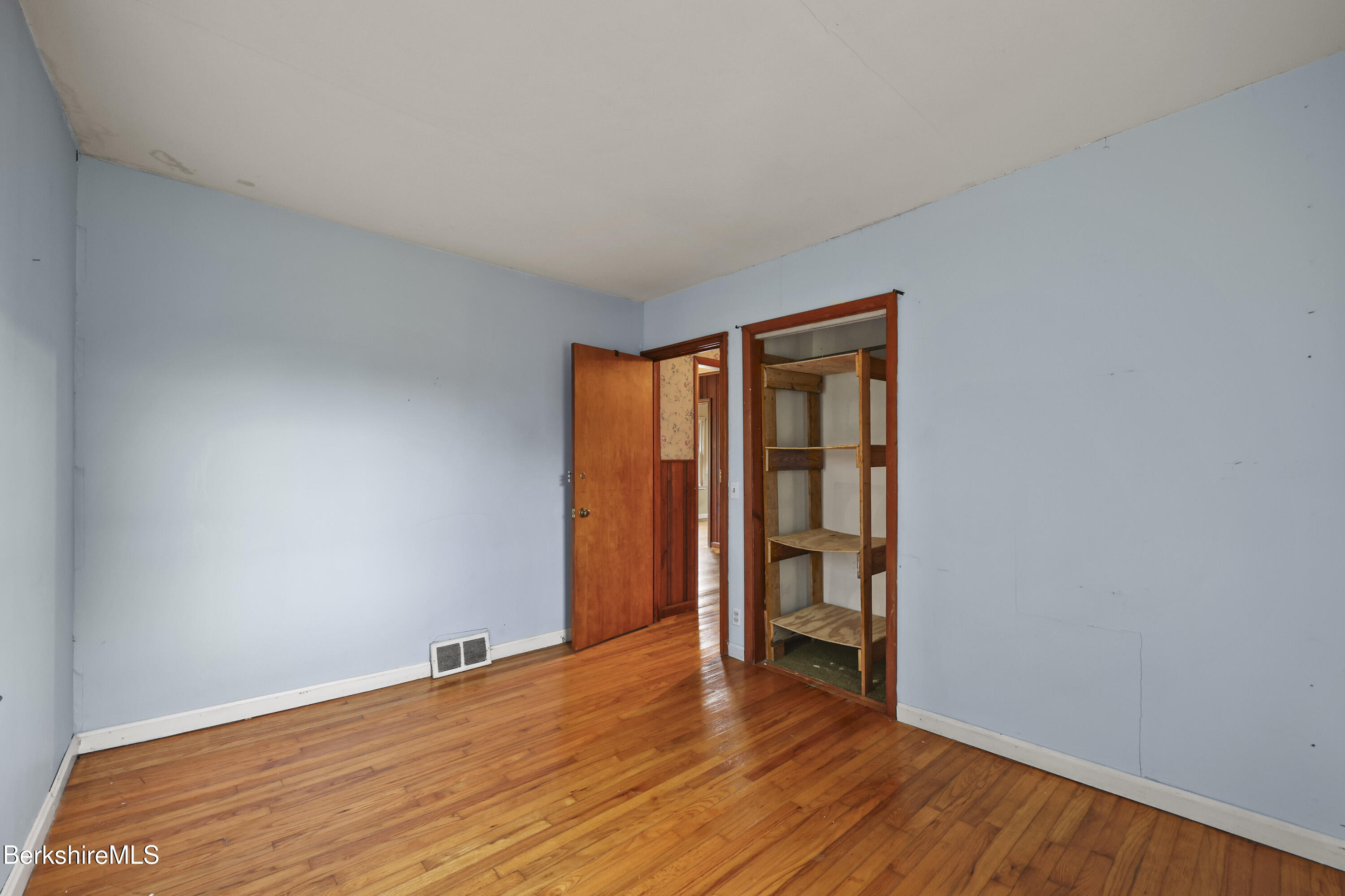 399 State Road Richmond, MA 01201 - Photo 24 of 43 a view of an empty room with wooden floor and a window