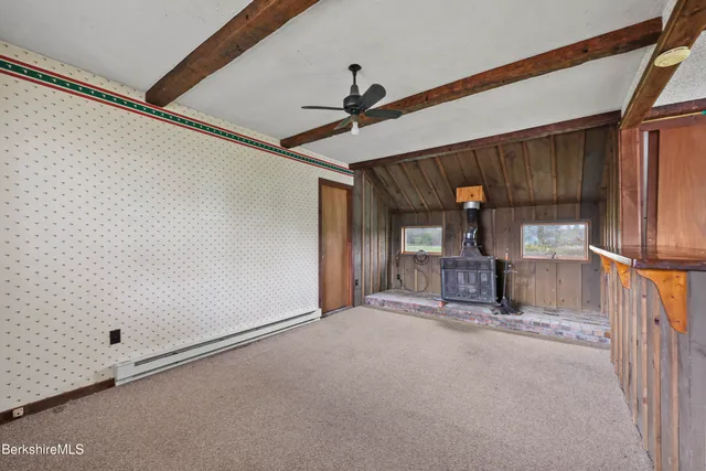 a view of a hallway with a ceiling fan