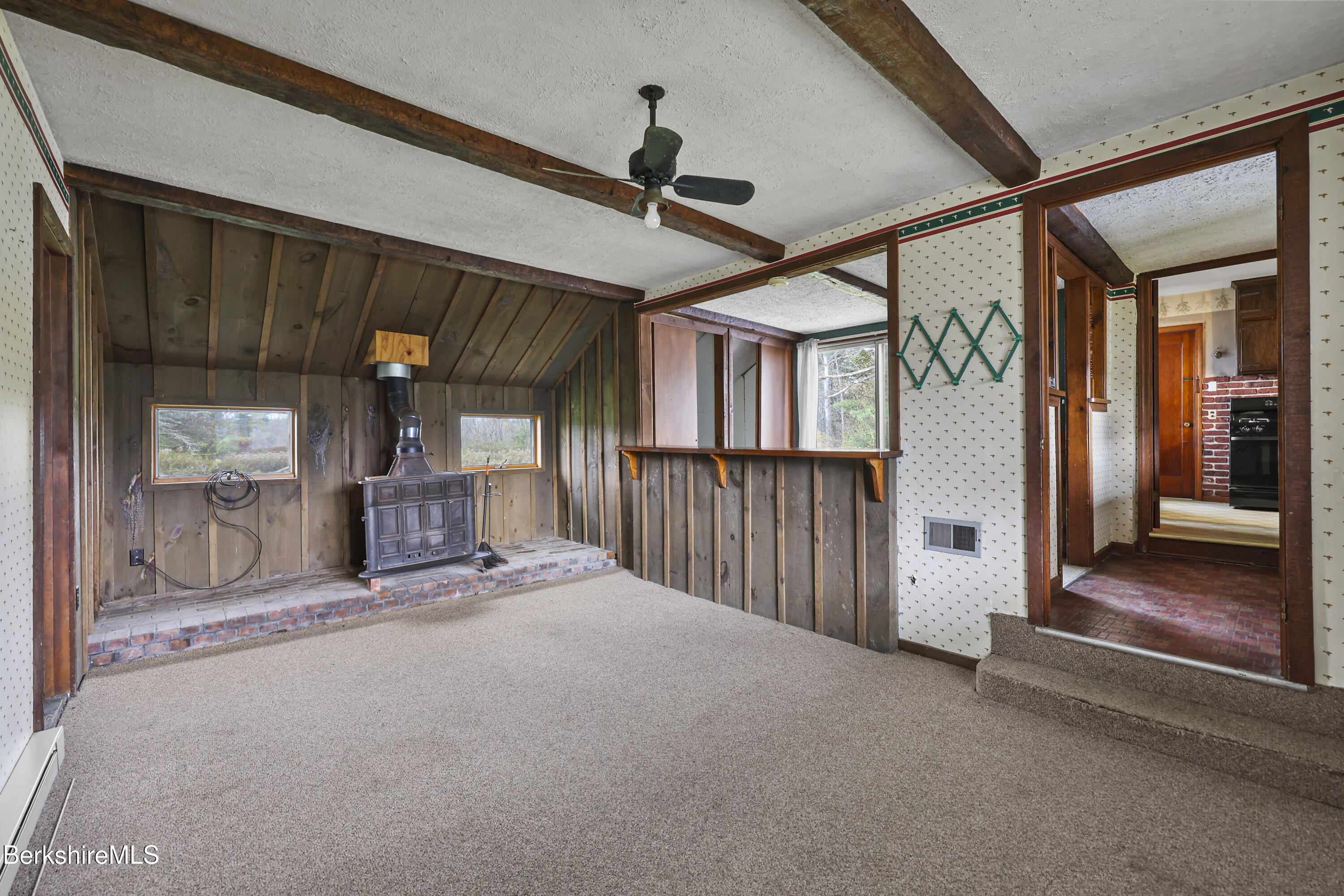 399 State Road Richmond, MA 01201 - Photo 28 of 43 a view of a hallway with wooden floor and a ceiling fan