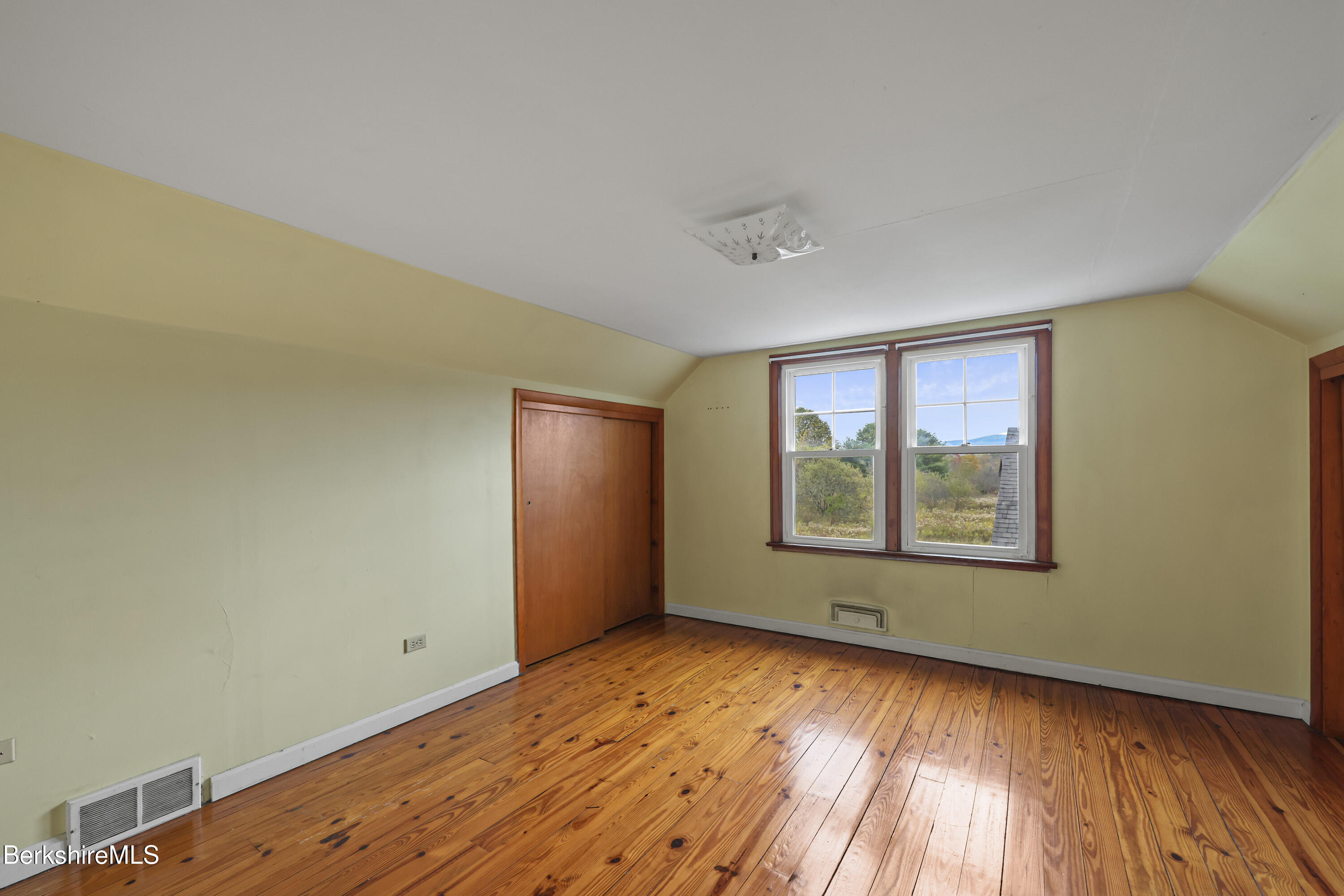 399 State Road Richmond, MA 01201 - Photo 30 of 43 an empty room with wooden floor and windows