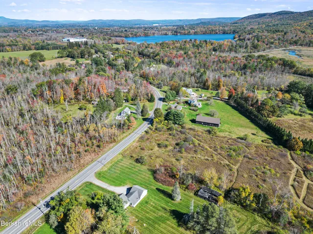 an aerial view of a house with a yard basket ball court and outdoor seating