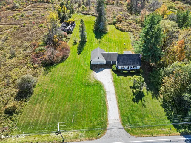 a aerial view of a house next to a yard