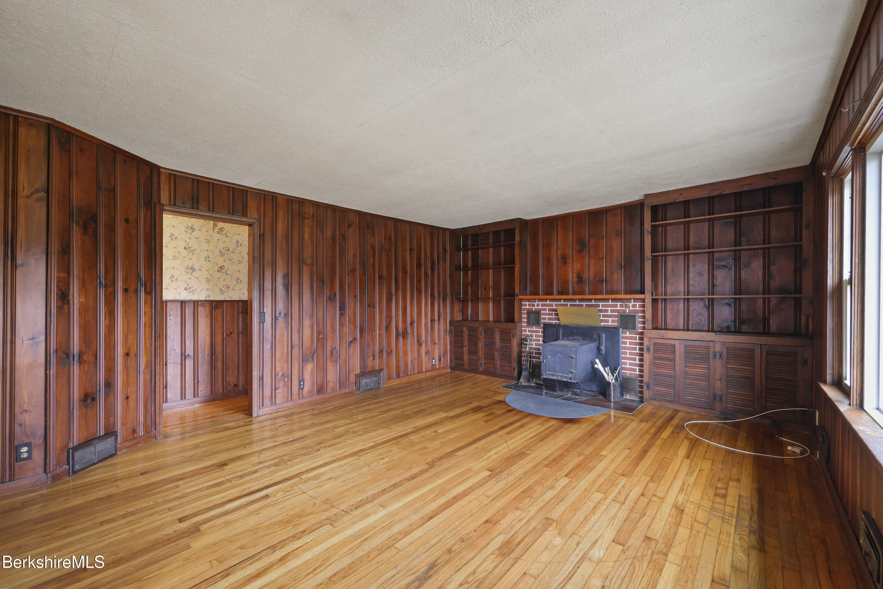 399 State Road Richmond, MA 01201 - Photo 9 of 43 an empty room with wooden floor and windows