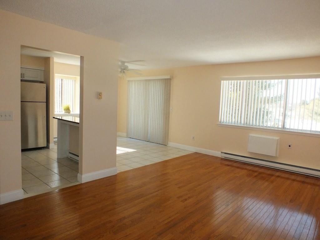 93 Kent Court, Unit 93 Meriden, CT 06450 - Photo 8 of 27 an empty room with wooden floor and windows