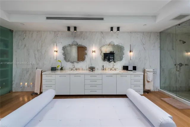 a kitchen with white cabinets and sink