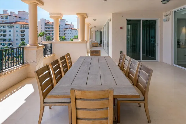 a living room with furniture a large window and wooden floor