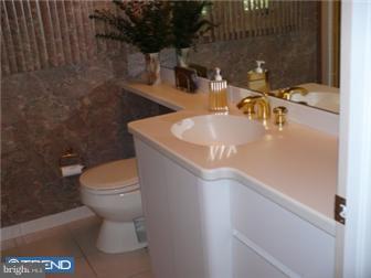 2038 Valley Road Jenkintown, PA 19046 - Photo 8 of 12 a bathroom with a sink a toilet and mirror