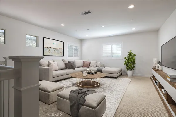 a living room with furniture a couch and a flat screen tv