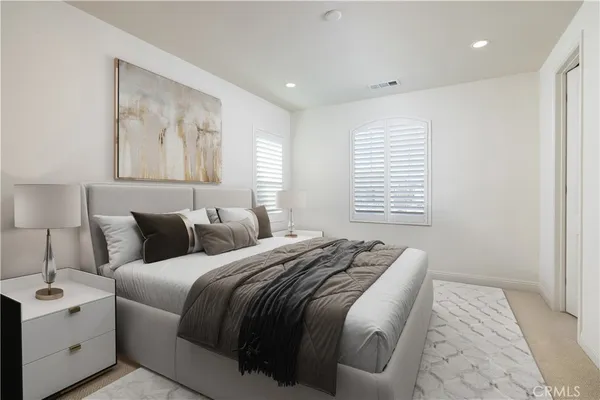 a bedroom with a large bed and a window