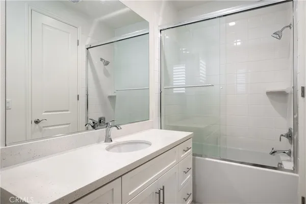 a bathroom with a granite countertop sink a shower and a mirror