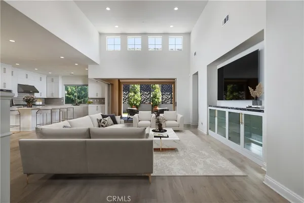 a living room with furniture tv and a large window