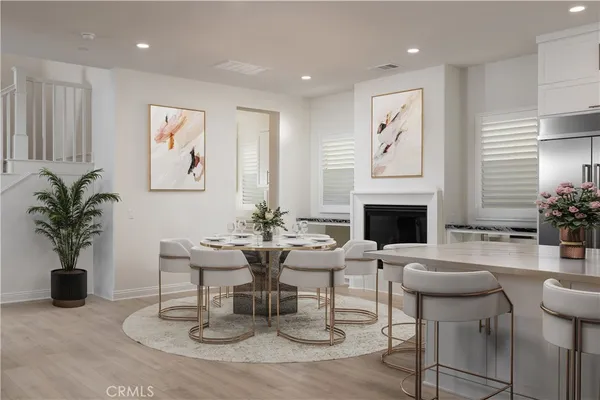a living room with furniture a fireplace and a potted plant