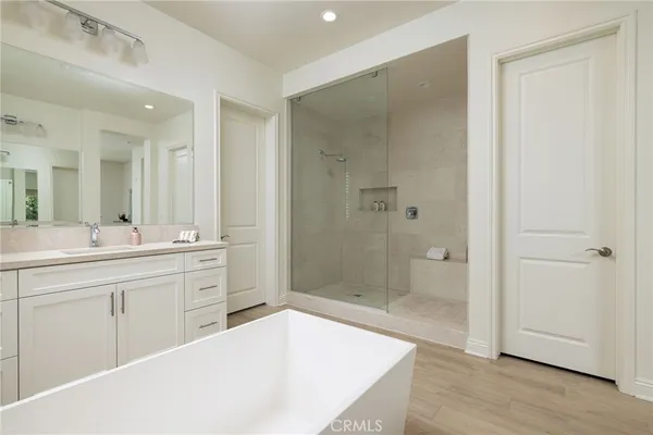 a spacious bathroom with a shower sink and mirror
