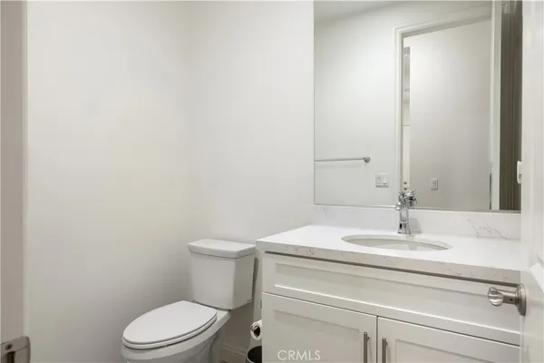 a bathroom with a sink a toilet and mirror