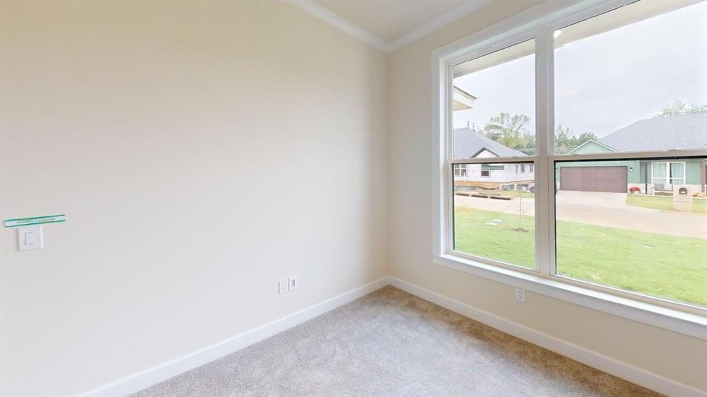 2509 Windmill Lane Longview, TX 75601 - Photo 23 of 35 Carpeted spare room with baseboards and ornamental molding