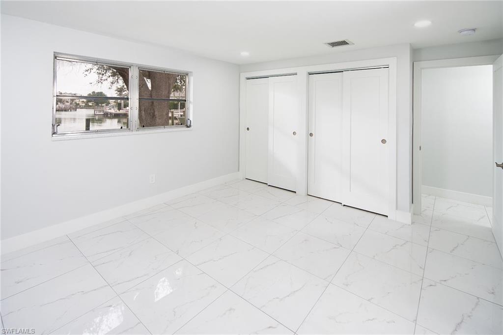 320 Bow Line Drive Naples, FL 34103 - Photo 12 of 20 a view of an empty room with a window