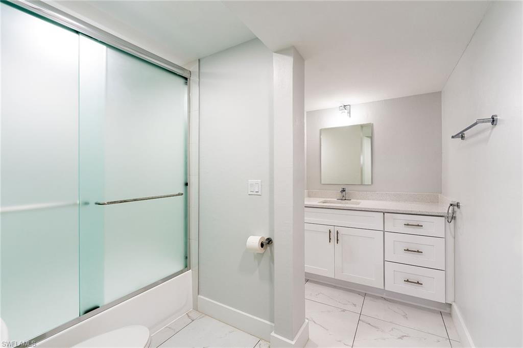 320 Bow Line Drive Naples, FL 34103 - Photo 16 of 20 a bathroom with a granite countertop sink and a mirror
