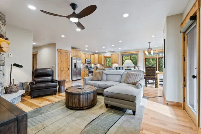 a living room with furniture and a chandelier