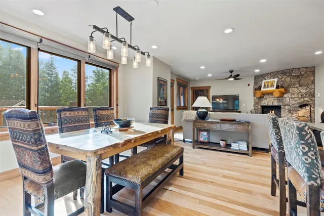 a living room with stainless steel appliances furniture a rug and a kitchen view
