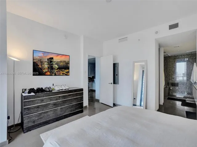 a bedroom with furniture and flat screen tv