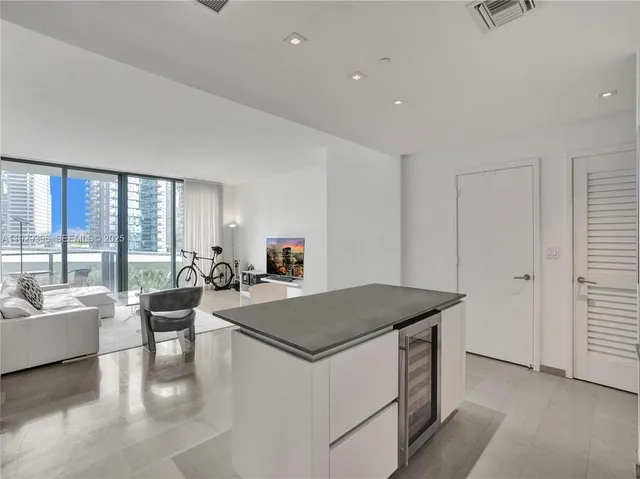a living room with kitchen island furniture and a table