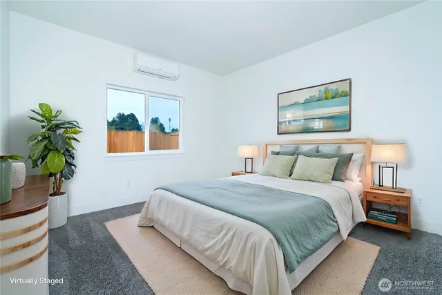 a bedroom with a bed and a painting on the wall