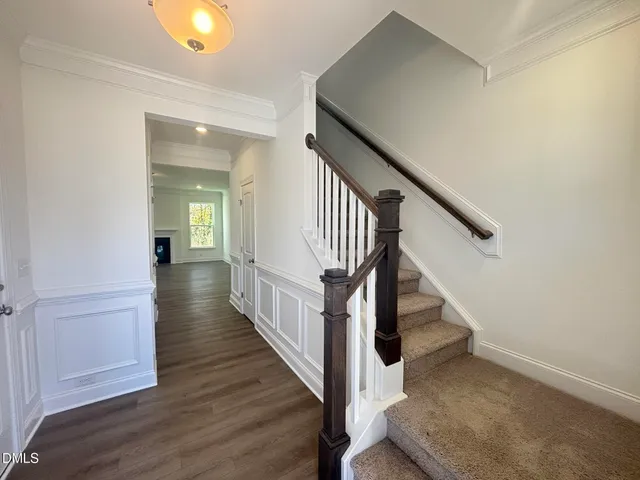 a view of a hallway with wooden floor and entryway
