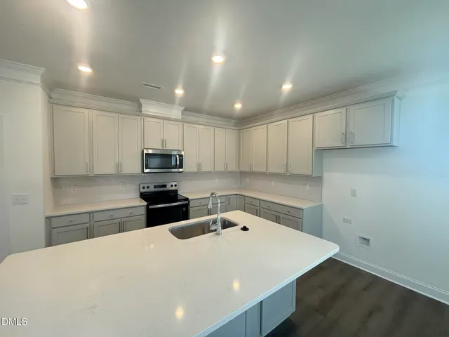 a kitchen with a refrigerator and a sink
