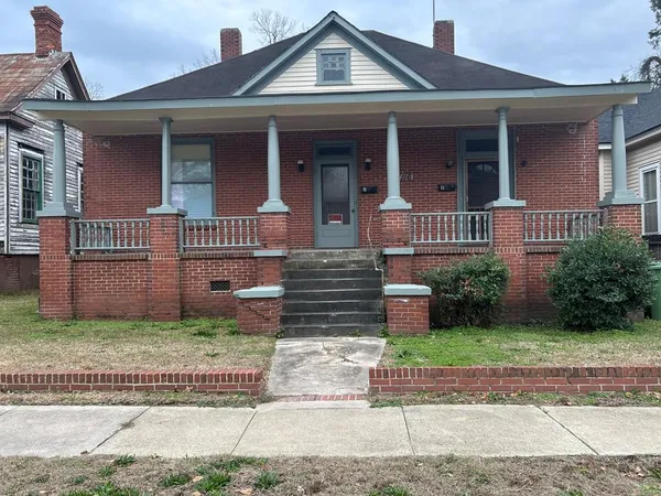 a front view of a house with a garden