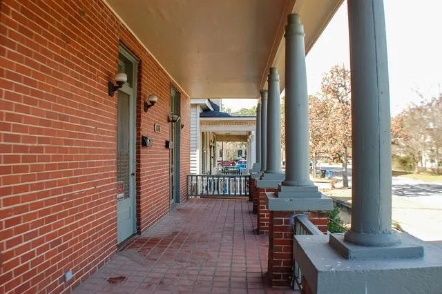 a kitchen with a stove and wooden floor