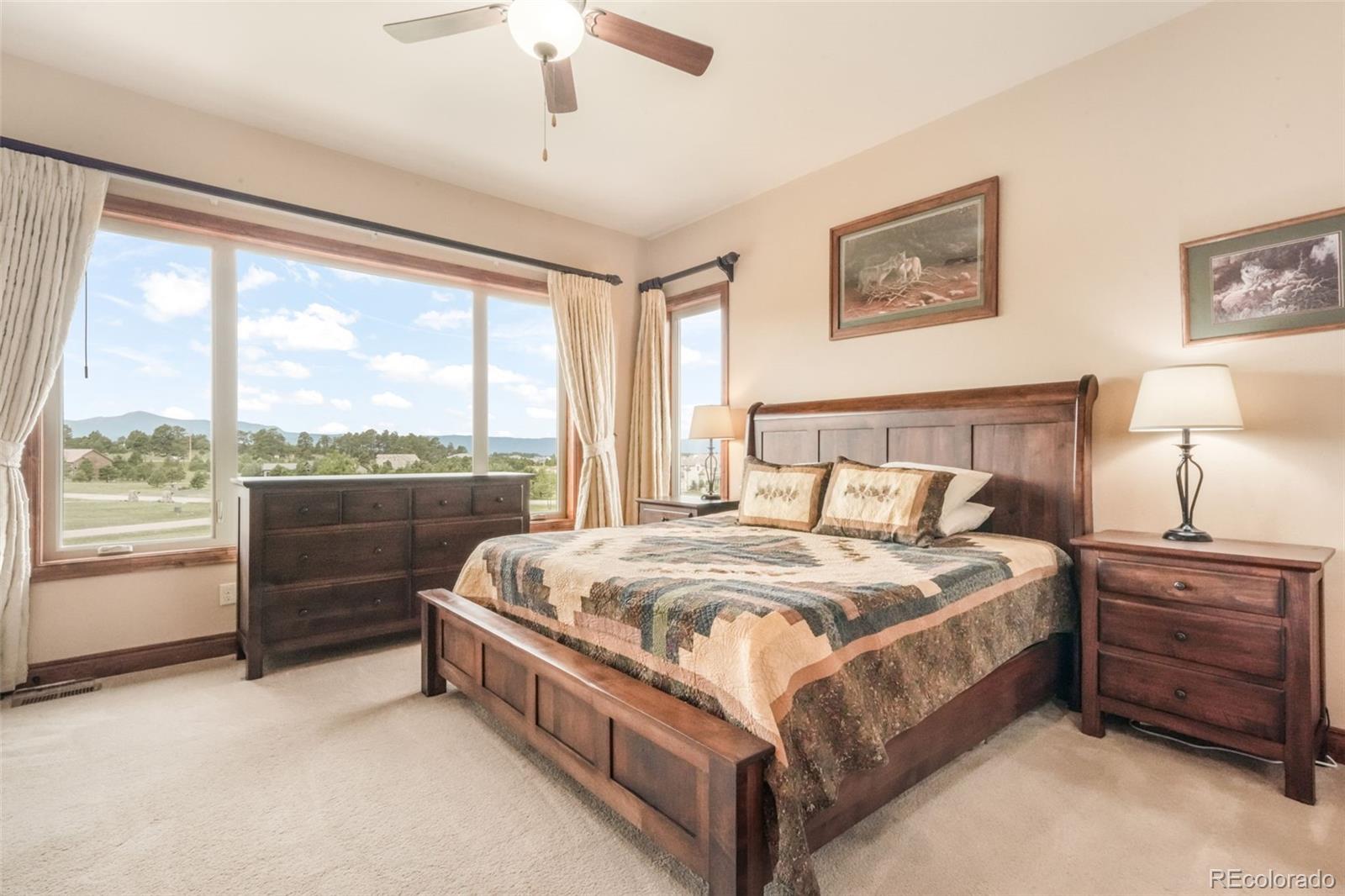 4330 Settlers Ranch Road Colorado Springs, CO 80908 - Photo 18 of 50 a large bed sitting in a bedroom next to a window