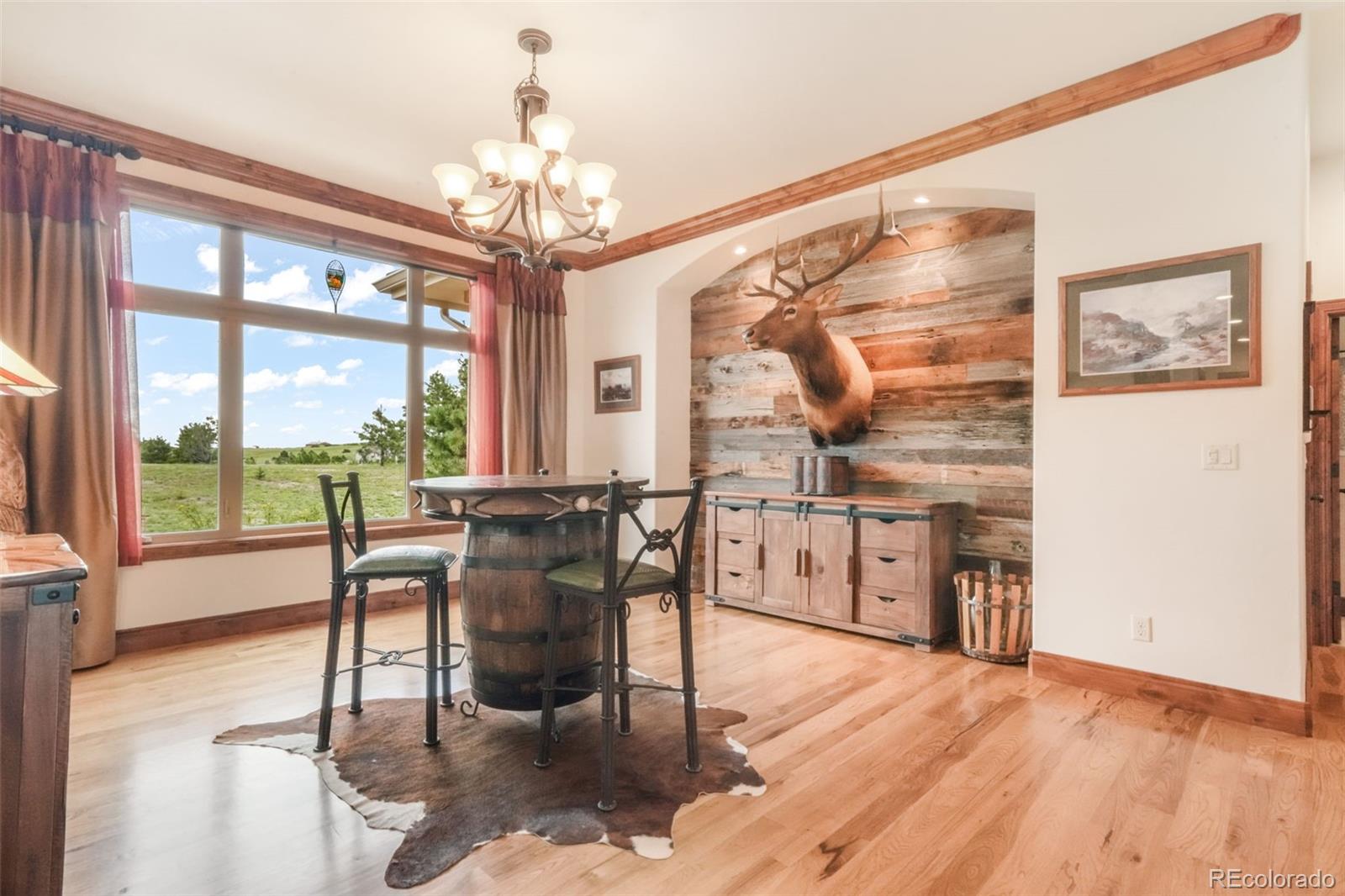 4330 Settlers Ranch Road Colorado Springs, CO 80908 - Photo 23 of 50 a view of a dining room with furniture wooden floor and chandelier