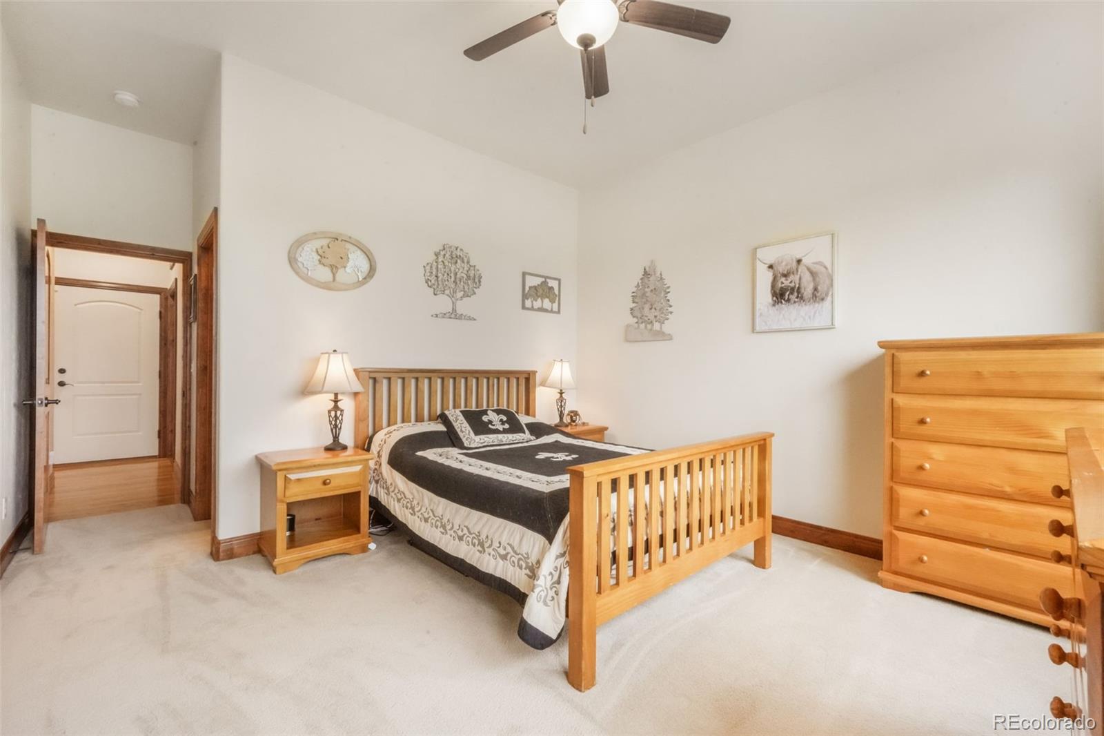 4330 Settlers Ranch Road Colorado Springs, CO 80908 - Photo 27 of 50 a spacious bedroom with a bed and a chandelier