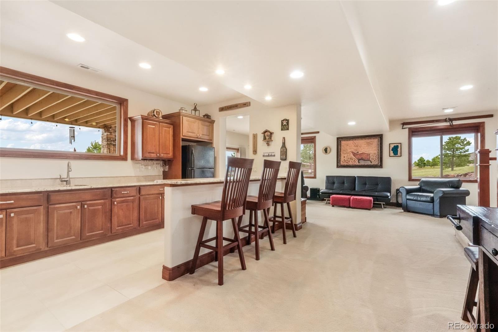4330 Settlers Ranch Road Colorado Springs, CO 80908 - Photo 37 of 50 a large kitchen with a table and chairs in it