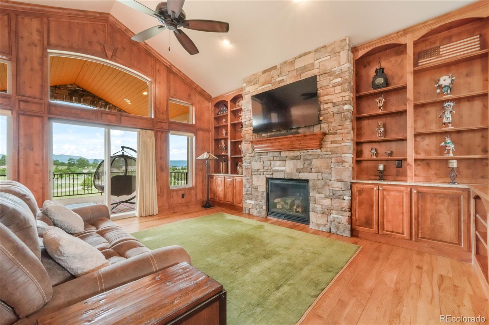 4330 Settlers Ranch Road Colorado Springs, CO 80908 - Photo 6 of 50 a living room with furniture a fireplace and a flat screen tv