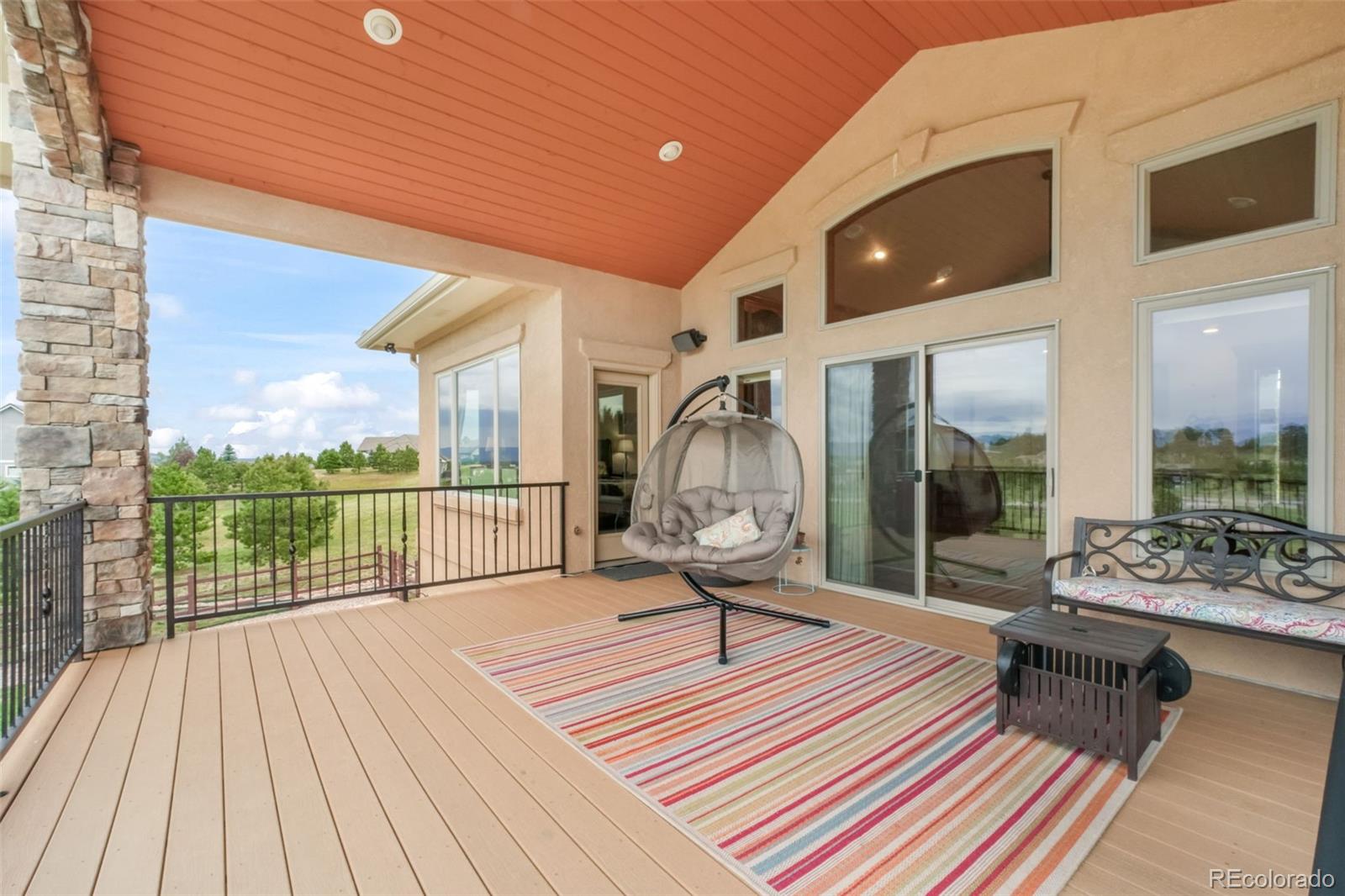 4330 Settlers Ranch Road Colorado Springs, CO 80908 - Photo 10 of 50 a balcony with chairs and wooden floor