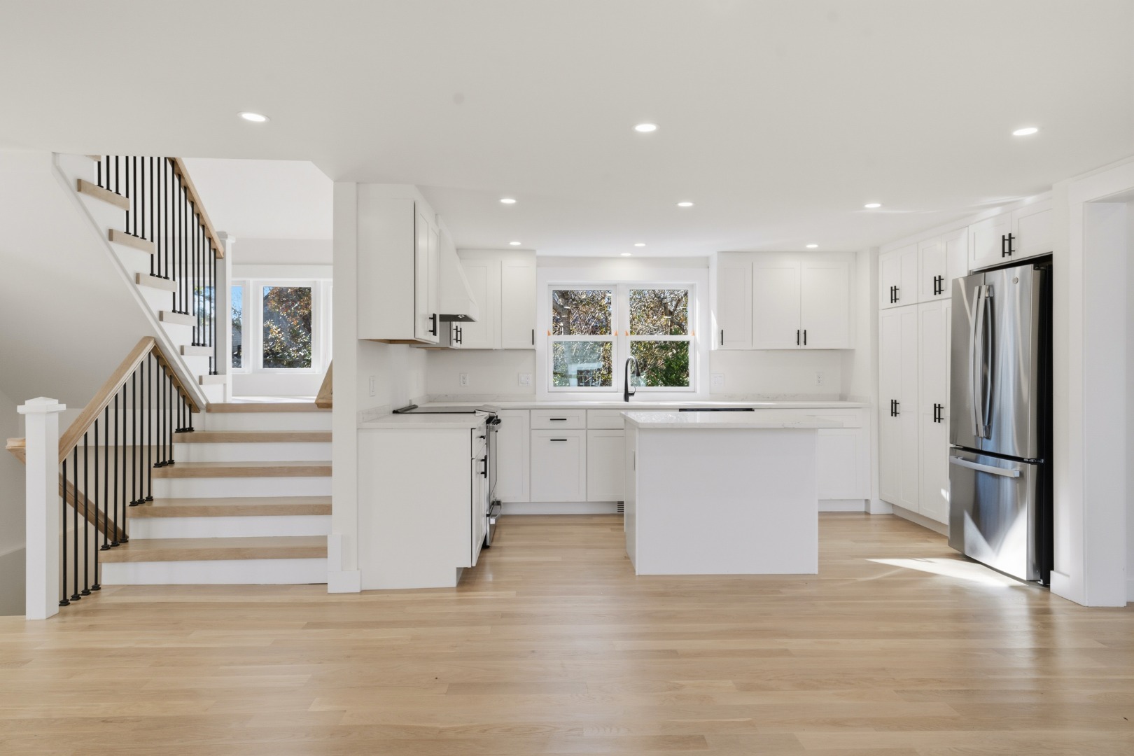 38 Hooper Farm Road Nantucket, MA 02554 - Photo 9 of 19 a kitchen with white cabinets and stainless steel appliances
